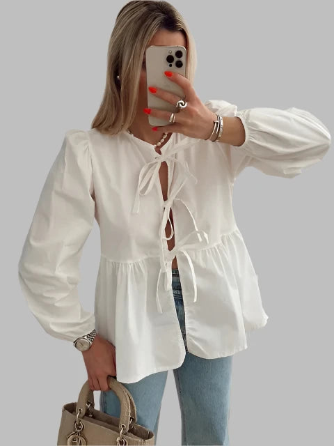 Women's blouse with puff sleeves and bow detail